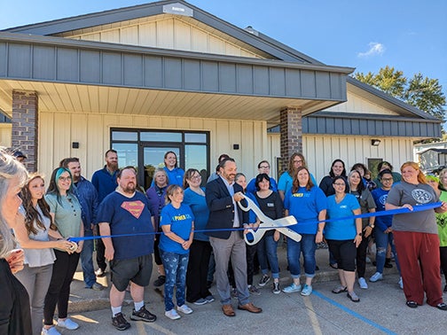 CRC President and CEO Brad Fjelsta takes on ribbon-cutting duties at the September 28 celebration. Kirksville Center employees along with a number of CRC’s employees from its other three centers were in attendance to support the event. 